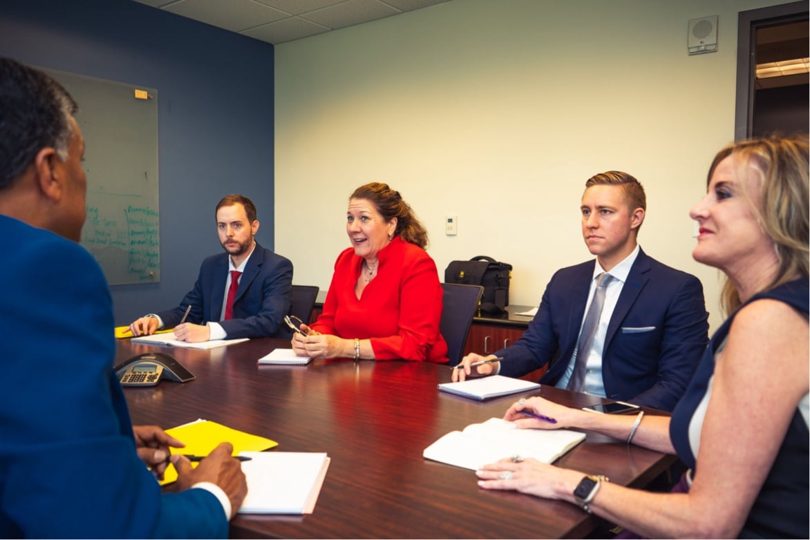 Team members in meeting around table